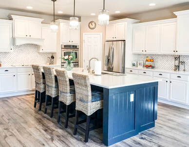 Updated kitchen with white cabinets and a blue island. New pendant lighting. Bright. clean. fresh.Picture