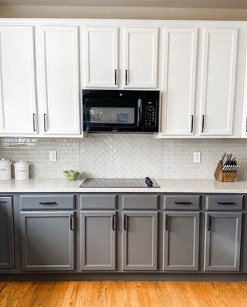 After picture of updated kitchen with freshly painted white upper cabinets and gray lower cabinets. New backsplash. modern. bright. clean.