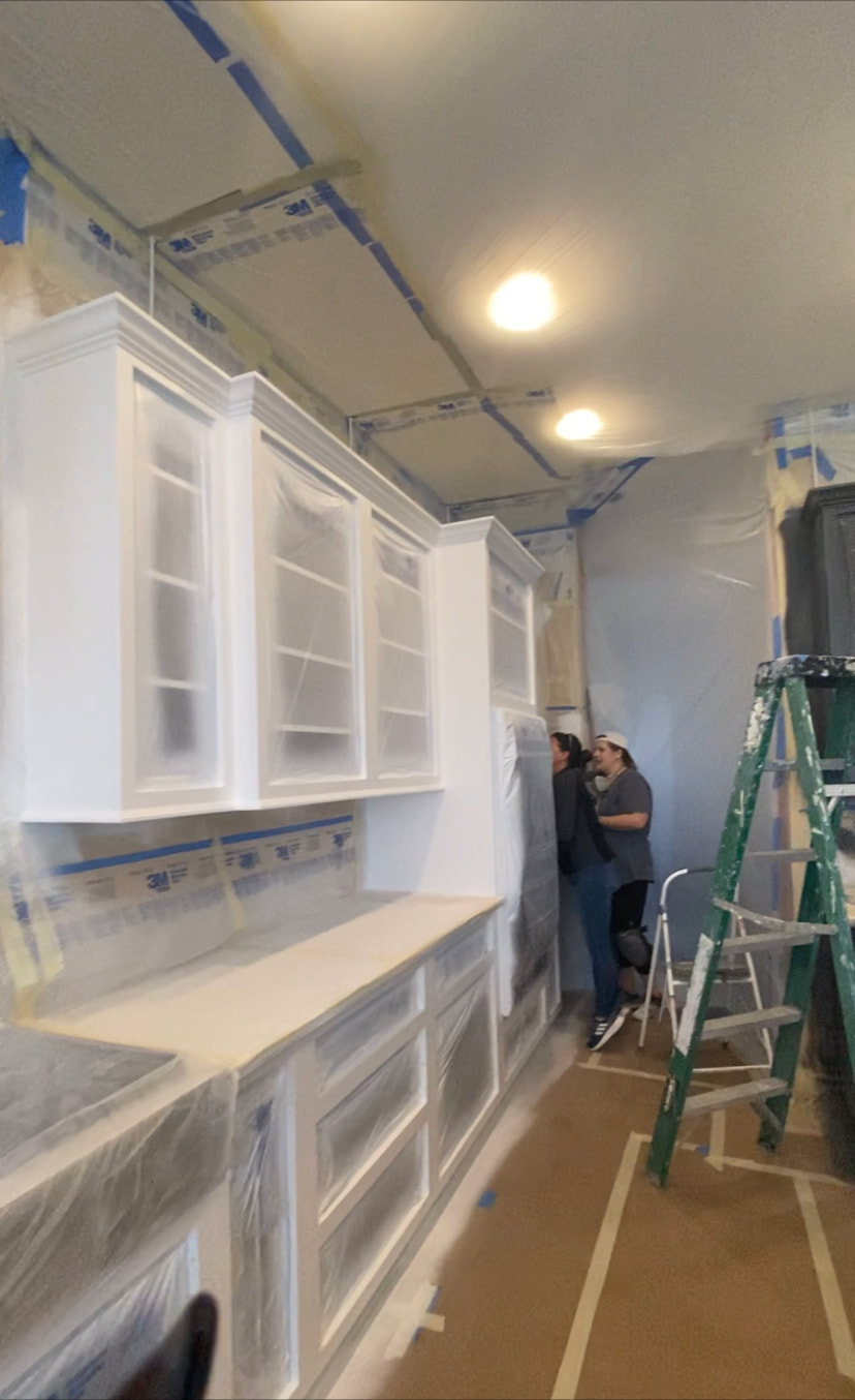 Masked off kitchen in the middle of the frame spraying process.